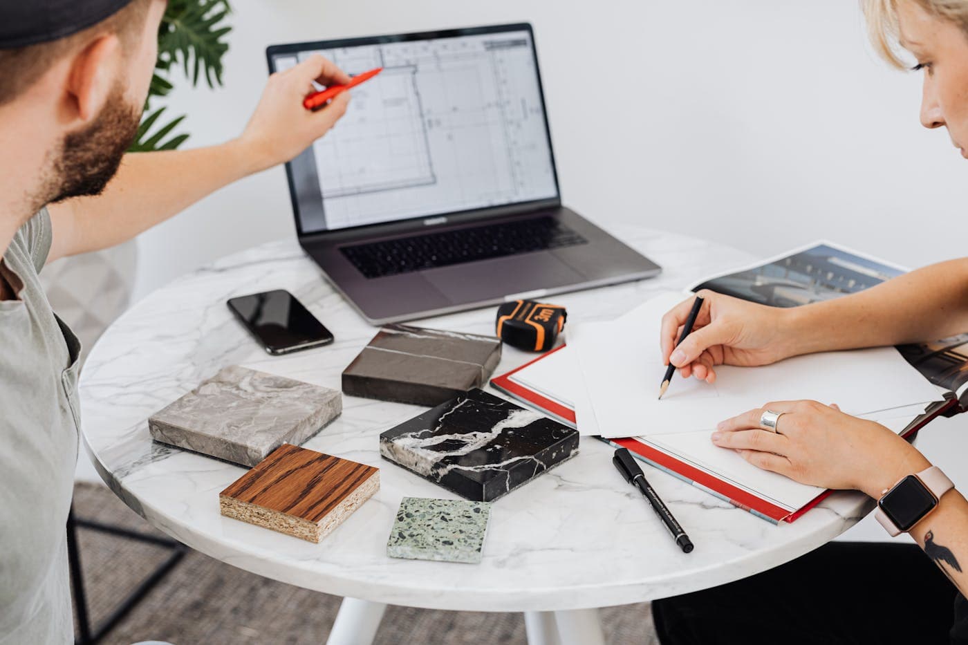 A product team reviewing mobile app interface designs.
